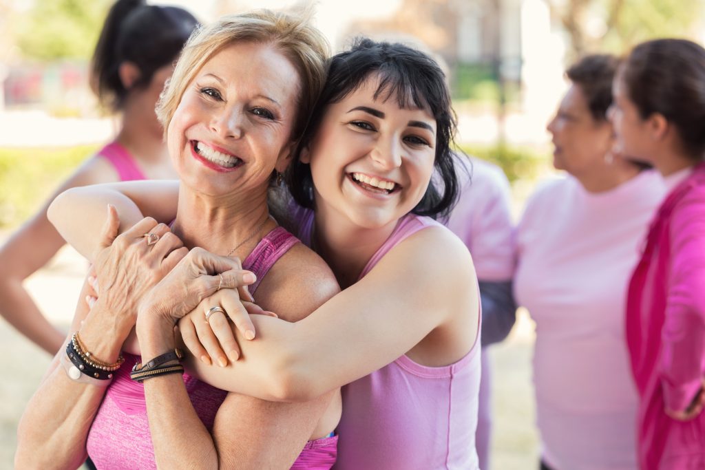 Granddaughter hugs grandmother at charity fun run for breast cancer