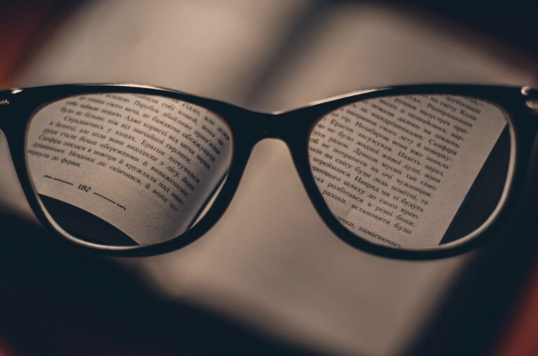 glasses hovering over an open book