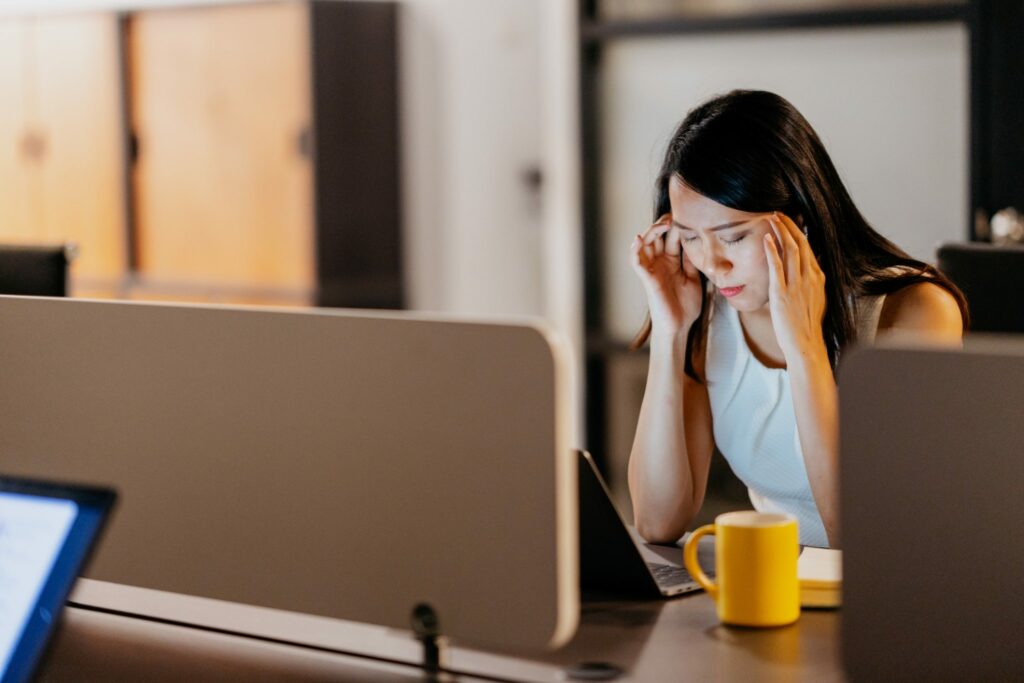 woman experiencing employee burnout and stress at laptop