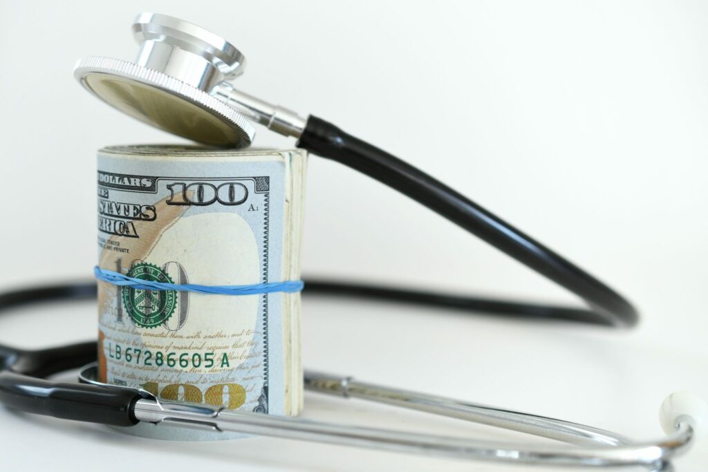Roll of money with stethoscope